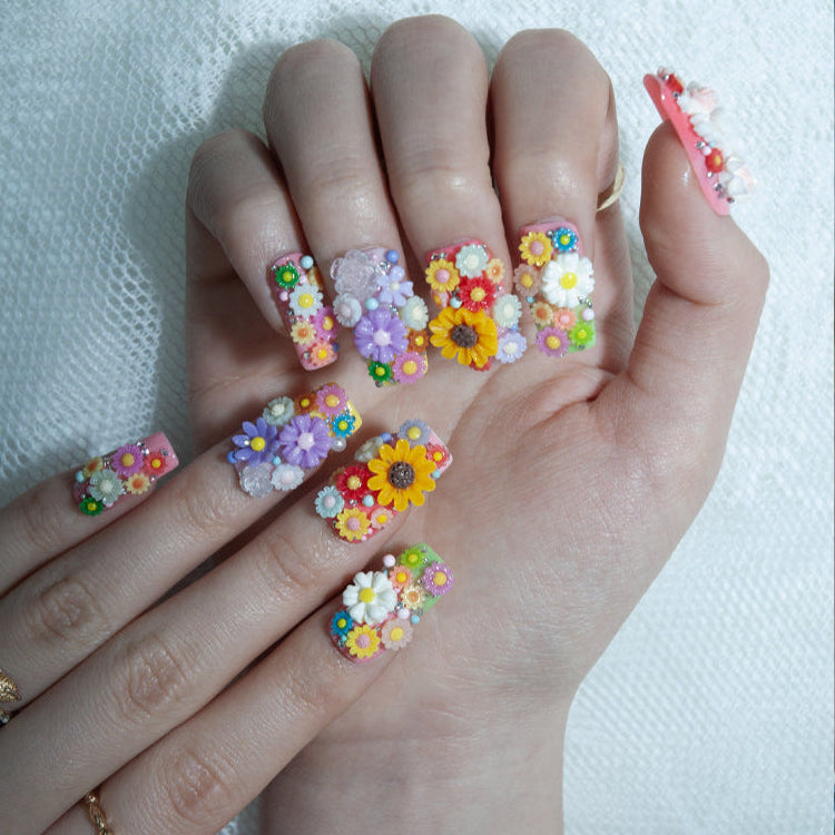 Handmade summer nails with rainbow flowers, butterfly, and garden theme