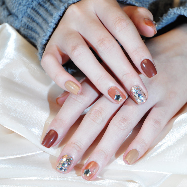 Handmade coffee and caramel tone nails with chunky glitter and 3D star designs
