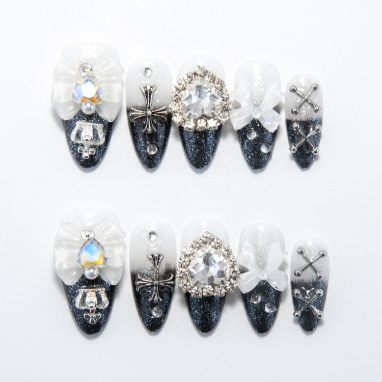 Black and white gradient press-on nails with silver cross and crystal bow