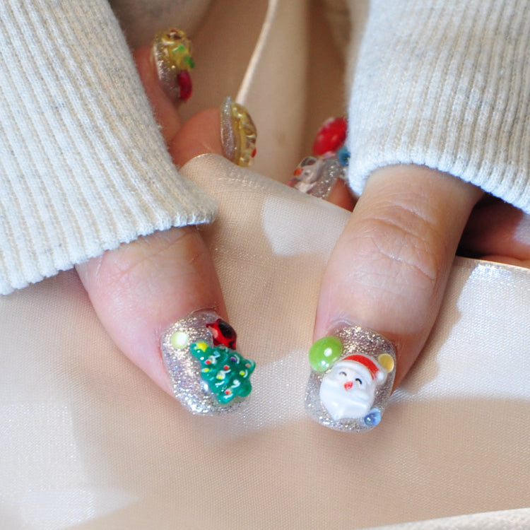 Colorful holiday press-on nails featuring 3D mitten, lollipop, and Christmas icons