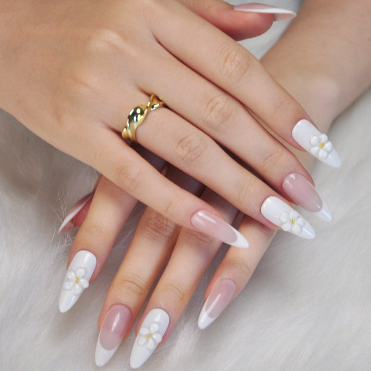 Elegant almond-shaped press-on nails with nude base and 3D white blossoms