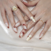 Handmade ombre nails in white and mocha brown with metallic gold details