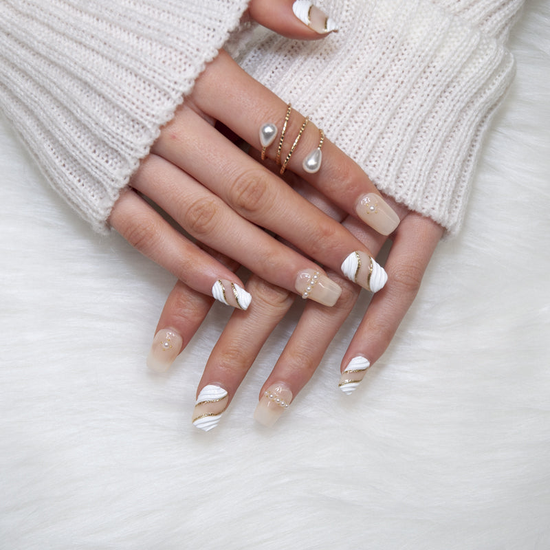 Short square handmade press-on nails in cream with 3D white swirl and gold stripe design