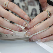 Elegant gradient nails with 3D gold butterfly, rhinestones, and shimmer accents