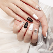 Handmade short coffin nails in monochrome moon phase pattern with metallic embellishment