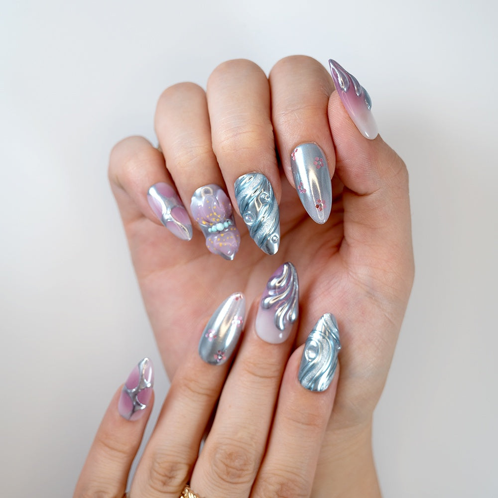 Metallic silver press-on nails with 3D chrome swirl and butterfly design