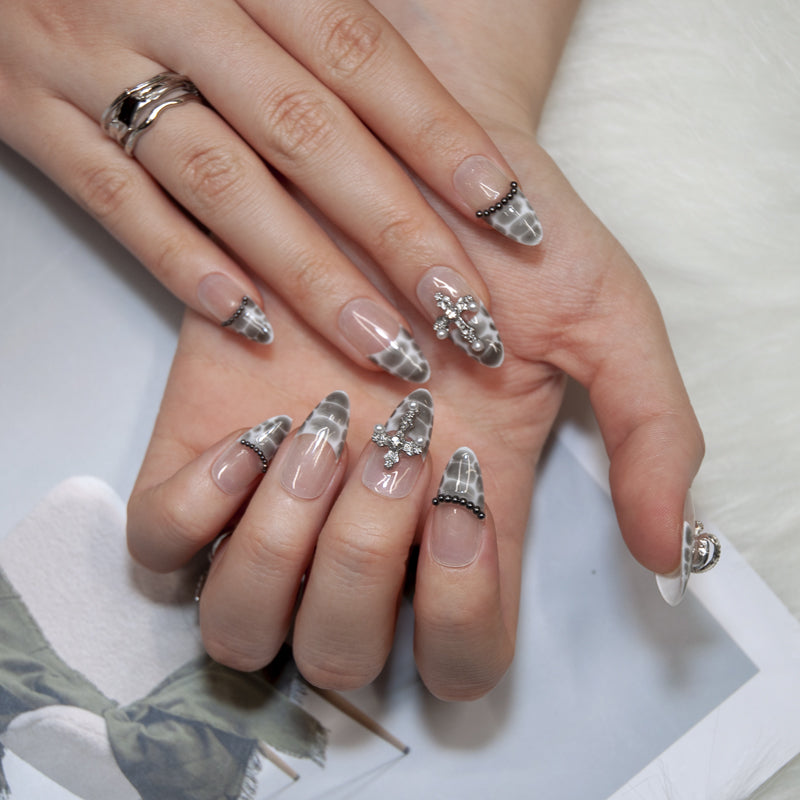 Luxury reptile-inspired press-on nails with gemstone planet detail and cross embellishment