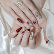 Romantic press-on nails with burgundy, nude marble, and metallic accents
