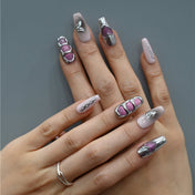 Modern metallic press-on nails with ombre base, silver cutouts, and glittery heart details