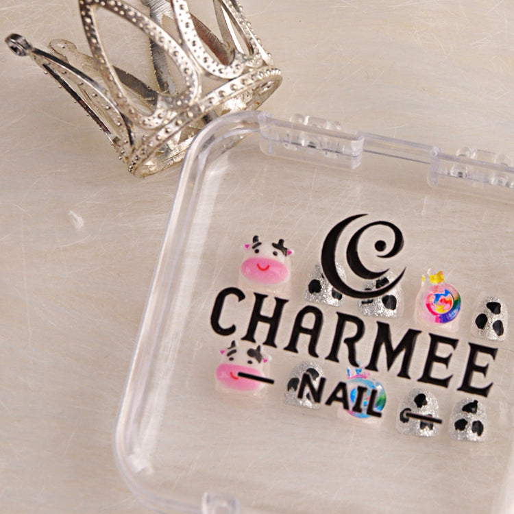 Handmade glitter nails with black cow spots, kawaii cow charm, and colorful lollipop