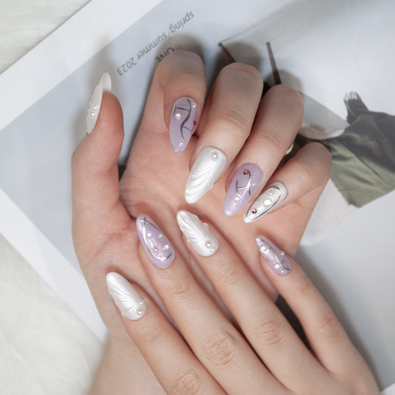 Elegant purple glitter nails with white 3D carvings and gemstone details