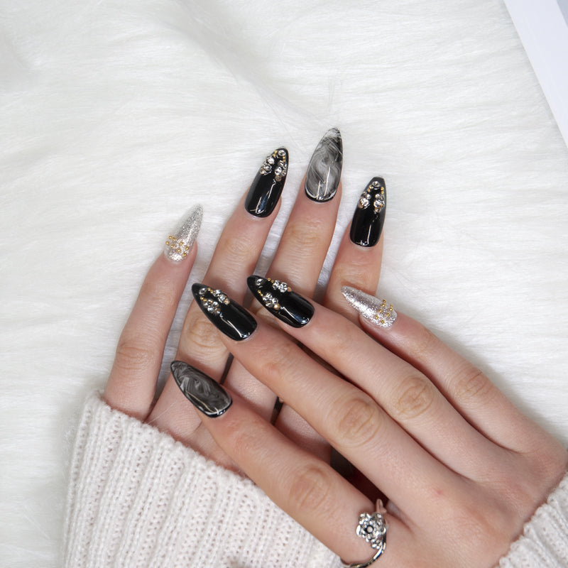 Handmade glossy nails with gemstone charms and marble swirl design