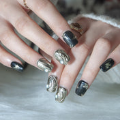 Handmade short square nails in glossy black with gold foil and 3D art details
