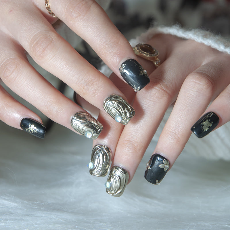 Handmade short square nails in glossy black with gold foil and 3D art details