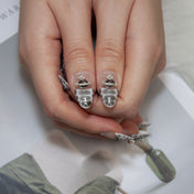 Elegant snake skin press-on nails with silver beads and 3D gemstone cross design