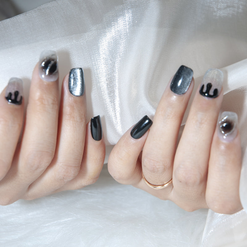 Edgy black press-on nails with silver shimmer and marble swirl