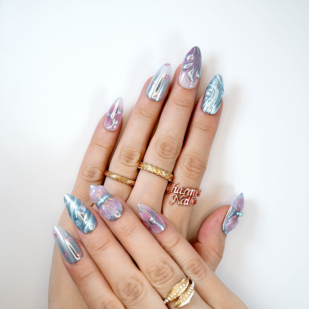 Futuristic silver chrome press-on nails with pastel pink ombré details