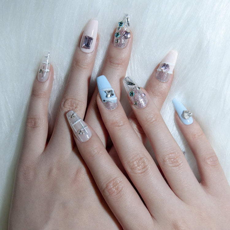 Elegant press-on nails with heart jewels, crystal stars, and holographic shine