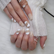 Elegant ivory press-on nails with pearl embellishment and glittery gold accents