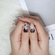 Elegant galaxy-inspired nails with gradient effect and sparkling stones