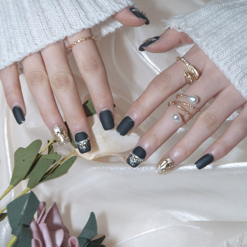 Square black nails with gold glitter feature nail and crystal diamond embellishments