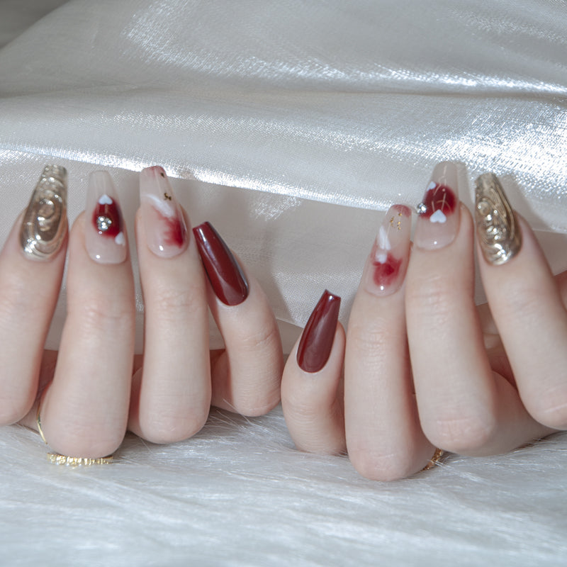 Valentine’s Day burgundy nails with love heart and gemstone design