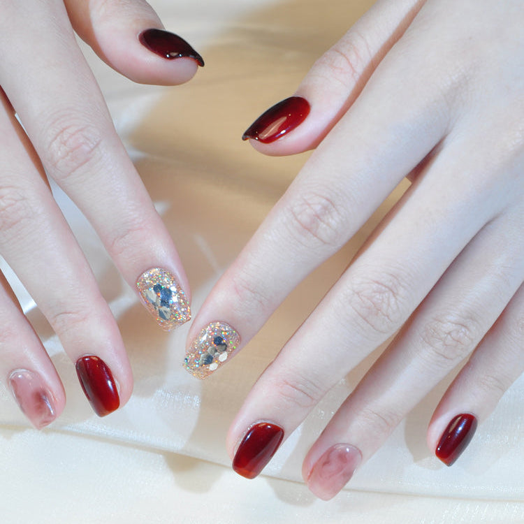 Luxury red and gold glitter press-on nails with crystal mosaic detail