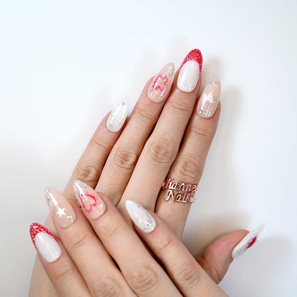 Valentine’s Day press-on nails featuring glossy red hearts and crystal decorations