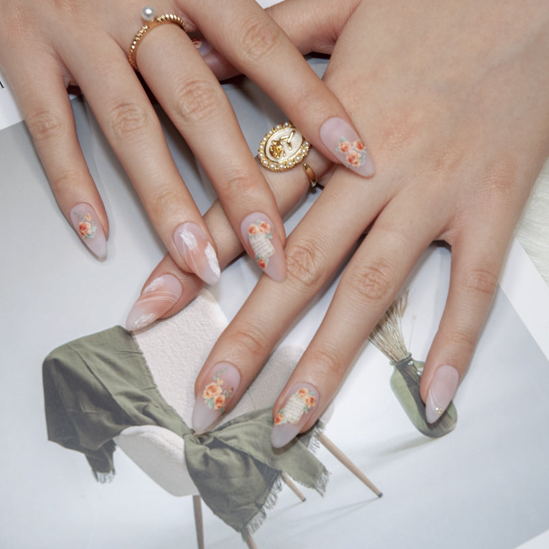 Romantic floral press-on nails with orange roses, script design, and soft gradient background