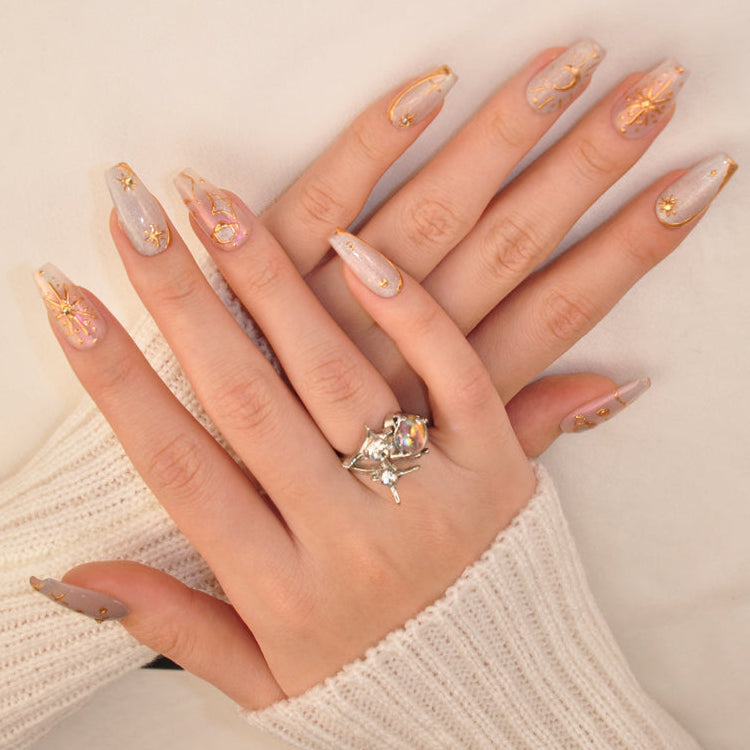 Luxury celestial nails with silver shimmer, gold 3D cosmic patterns, and starlight charm