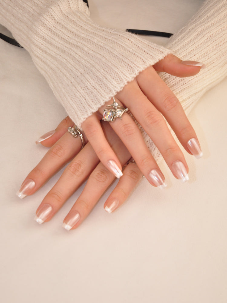 Handmade natural nails with subtle pearl shimmer and ombre white tips