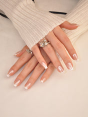 Handmade natural nails with subtle pearl shimmer and ombre white tips