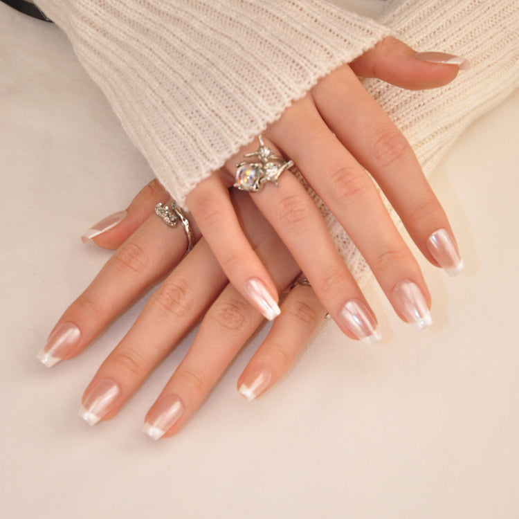 Handmade natural nails with subtle pearl shimmer and ombre white tips