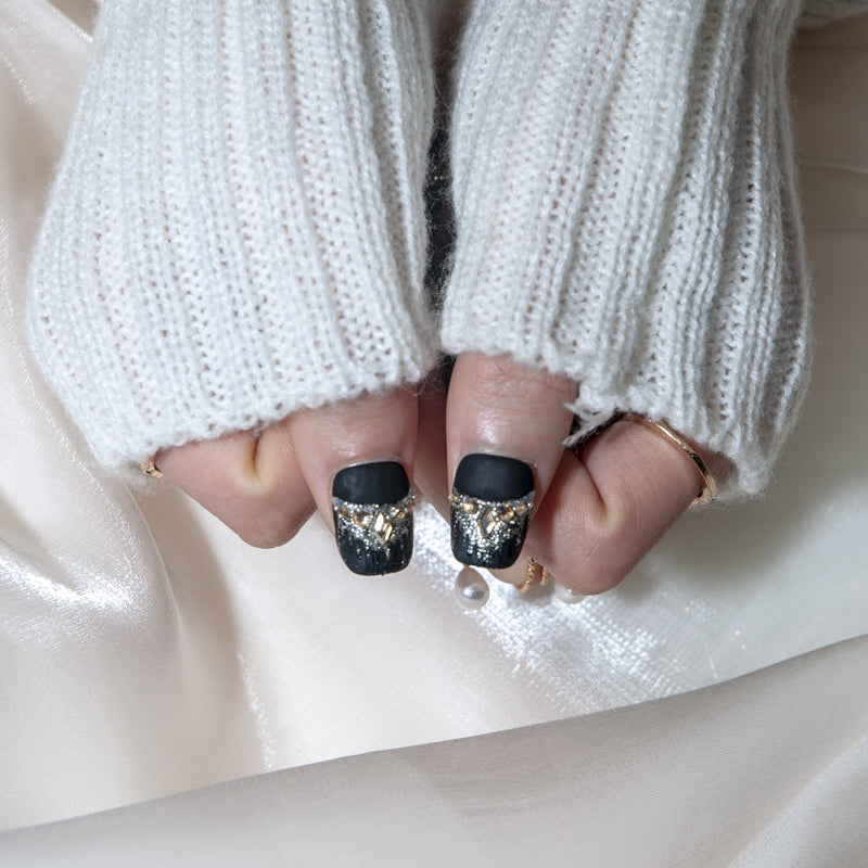Luxury handmade black and gold press-on nails with rhinestone and glitter details
