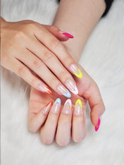 Trendy almond nails featuring bold colorful French tips for a playful summer look