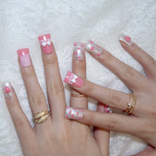 Cute pink and silver glitter nails with white bows and pearls