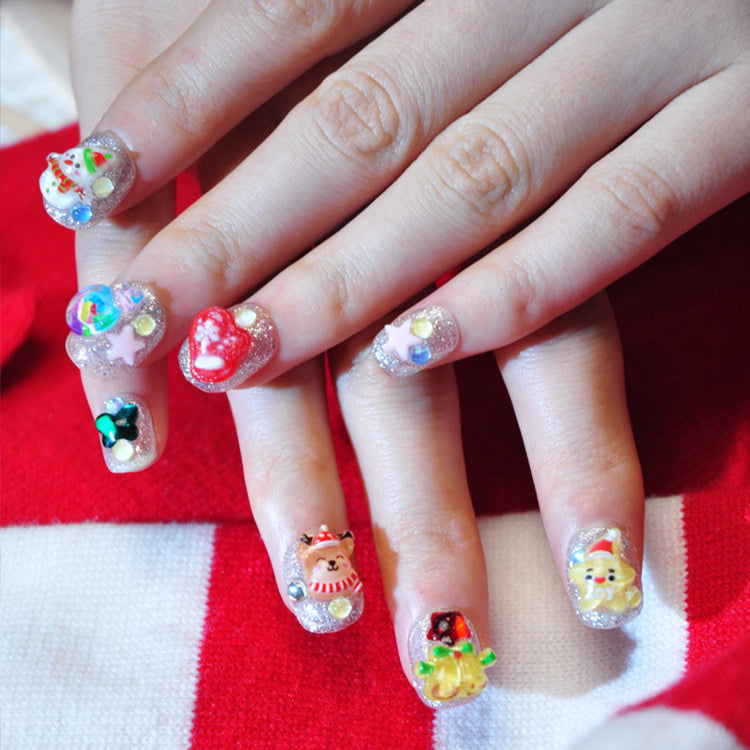 Handmade silver glitter nails with snowman, candy, bell, and festive star designs