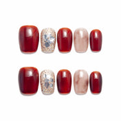 Short square press-on nails in wine red with marble beige and glittery gemstone design