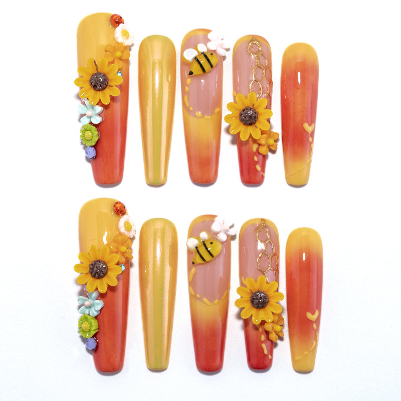 Sunflower and bee press-on nails with orange to yellow ombre