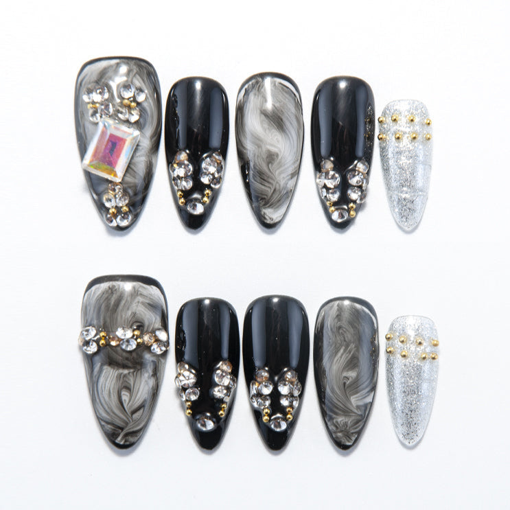 Black and white marble press-on nails with gold and silver rhinestone accents