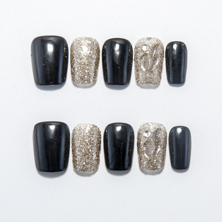 Black and gold glitter press-on nails with clear leaf pattern accent