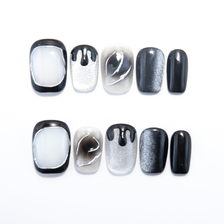 Black and white ombre press-on nails with silver glitter drip art