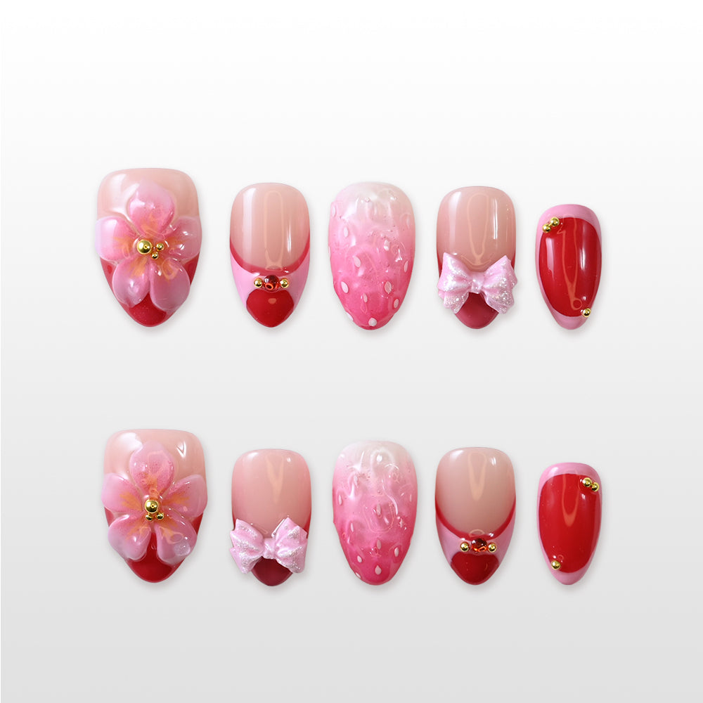 Strawberry-inspired press-on nails with 3D flower, pink bows, and glossy red tips