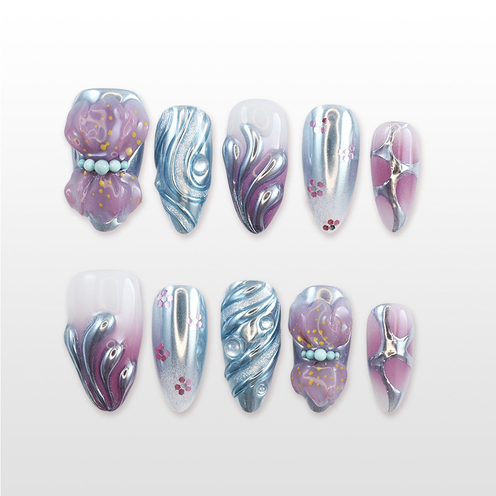 Handmade glossy nails featuring lavender-pink gradient, mirror chrome texture, and floral embellishments