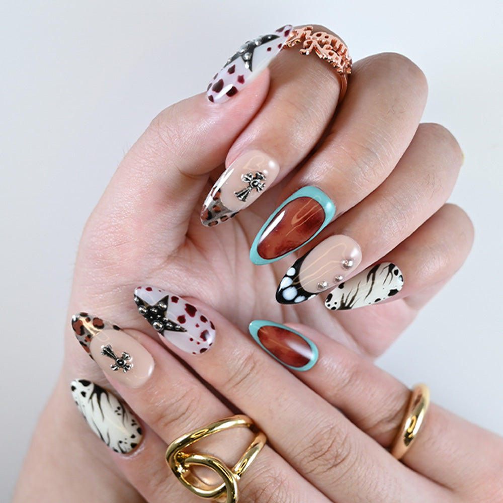 Almond shaped nails featuring zebra stripes, leopard tips, and turquoise framing