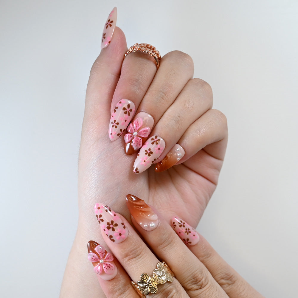 Cute spring press-on nails in pastel pink with daisy print design
