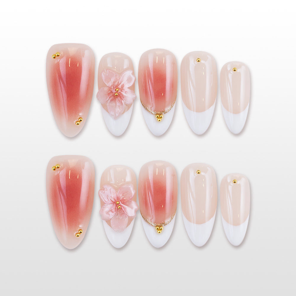 French tip press-on nails with pink gradient and 3D flower accent