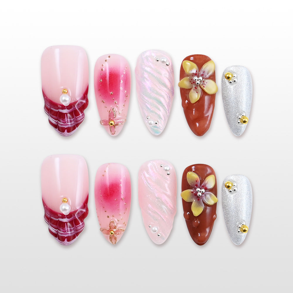Pink and red gradient press-on nails with 3D floral and metallic silver accent