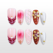 Pink and red gradient press-on nails with 3D floral and metallic silver accent