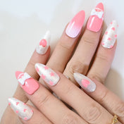 Sweet almond press-on nails with white bows, pearl decorations, and sparkly pink design